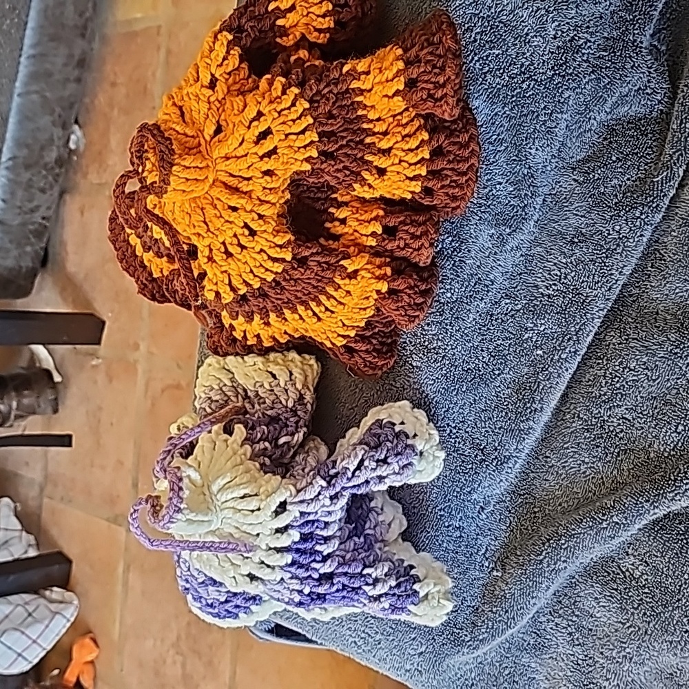Hand knitted doll display dresses pair
